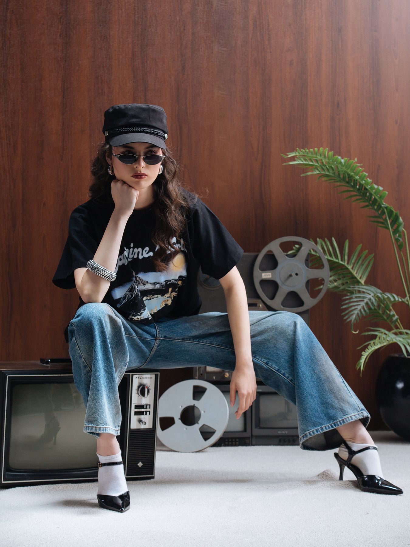 Model seated on a television set